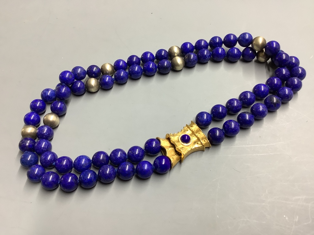 A lapis lazuli necklace with fancy gilt metal clasp, 42cm.